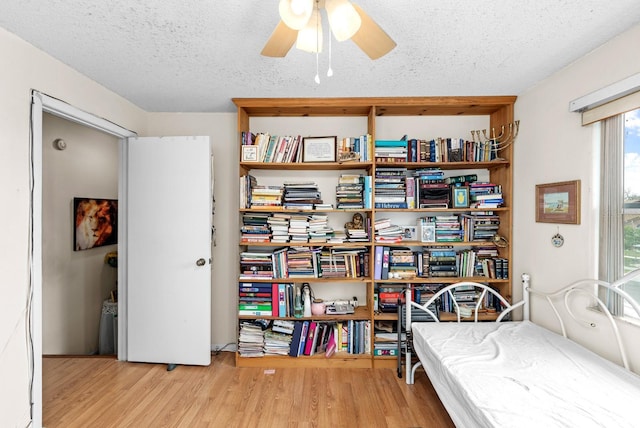 bedroom featuring a textured ceiling and light wood-type flooring