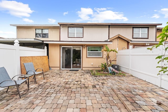 rear view of property featuring a patio area