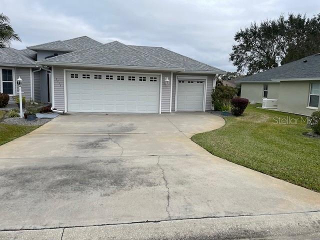 view of property exterior featuring a lawn and a garage