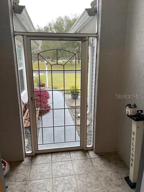 entryway featuring light tile patterned floors and a wealth of natural light