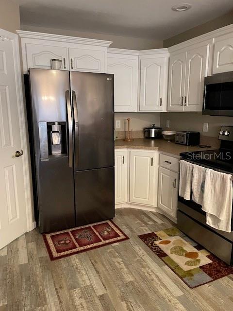 kitchen with white cabinetry and stainless steel appliances