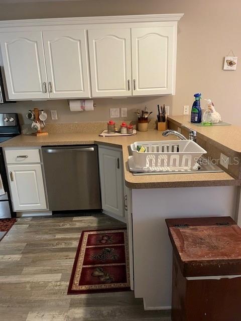 kitchen featuring white cabinetry, dark wood-type flooring, and appliances with stainless steel finishes