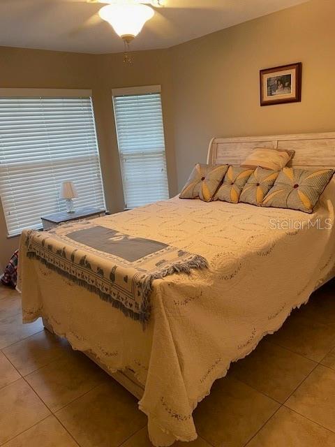 bedroom featuring ceiling fan and light tile patterned floors