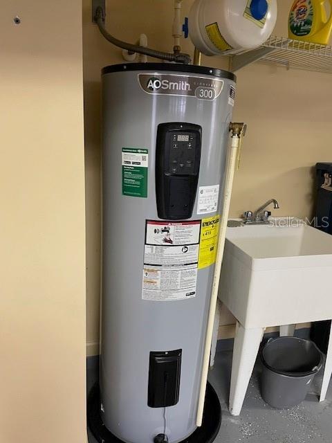 utility room featuring water heater