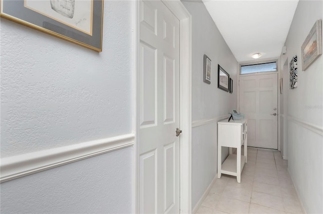 hall featuring light tile patterned flooring