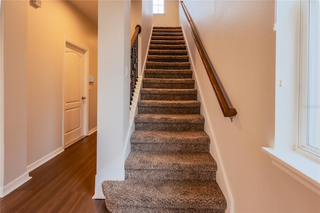 stairs with hardwood / wood-style flooring