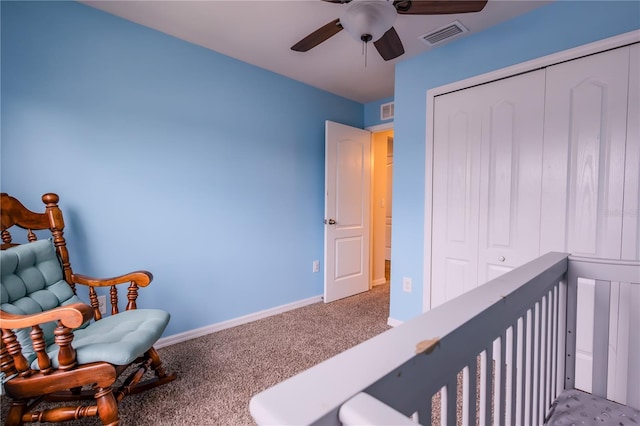 interior space with ceiling fan, a closet, and carpet flooring