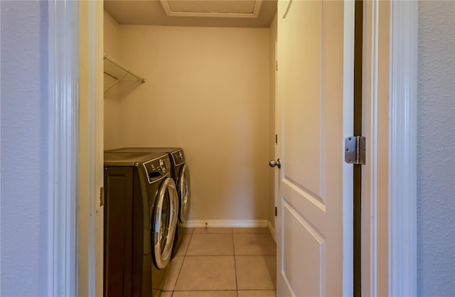 laundry room featuring washer and dryer and light tile patterned flooring