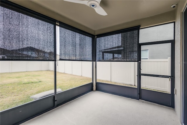 unfurnished sunroom with ceiling fan