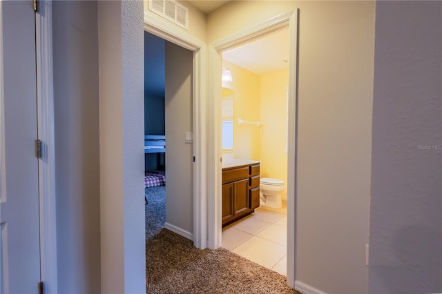 hall with light colored carpet