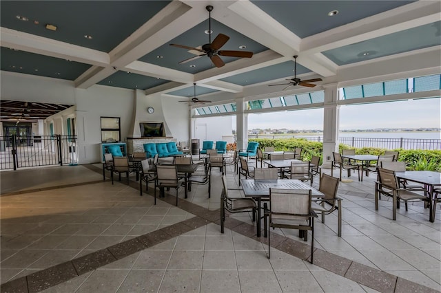 view of patio featuring ceiling fan and a water view