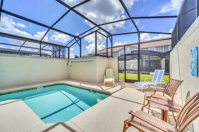 view of swimming pool featuring a lanai and a patio area