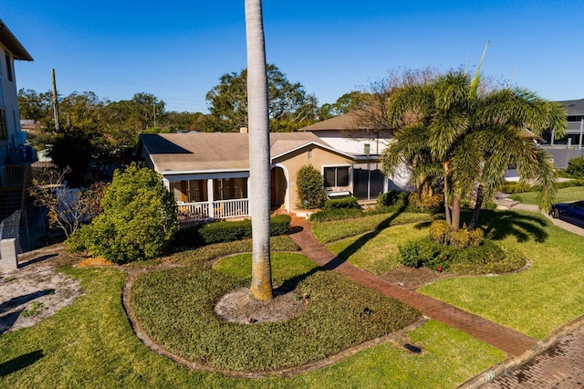 view of front of house with a porch and a front lawn