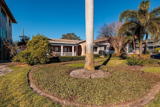 view of front of house featuring central AC unit and a front lawn