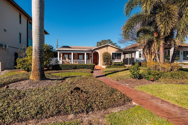 view of front of property with covered porch and a front yard