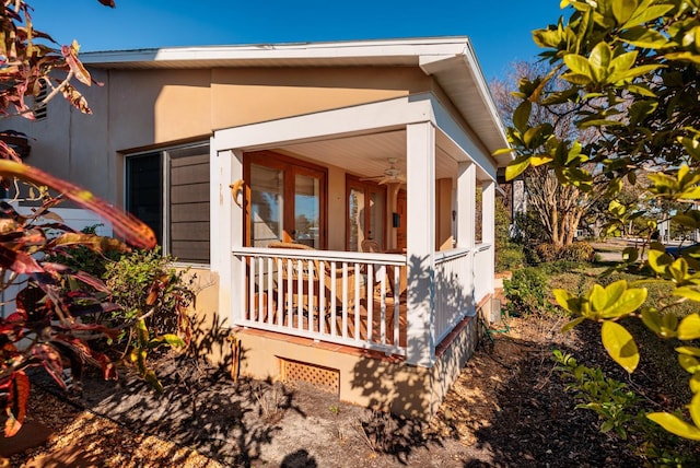 view of side of home featuring a porch and ceiling fan