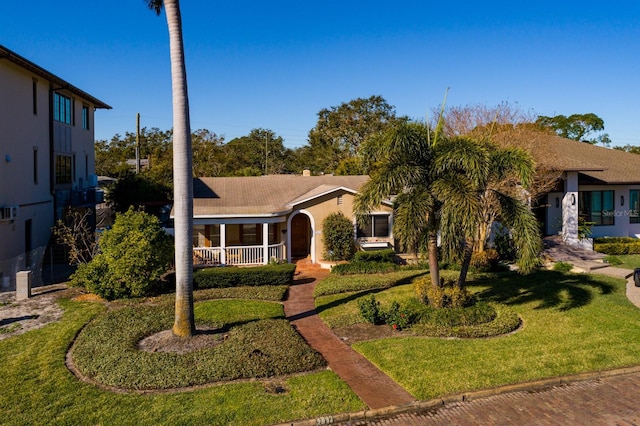 view of front facade with a porch and a front lawn