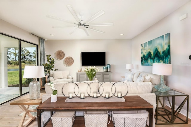 living room with ceiling fan and hardwood / wood-style flooring