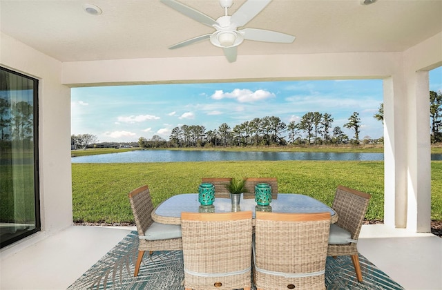 view of patio / terrace featuring a water view and ceiling fan