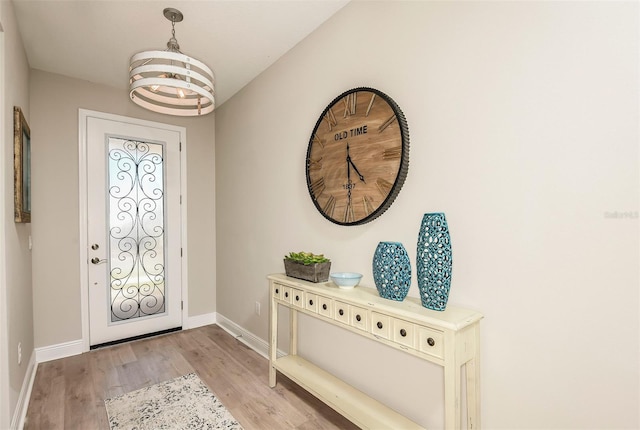 entryway featuring a chandelier and light wood-type flooring