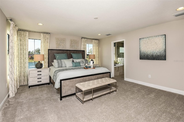 carpeted bedroom with ensuite bath