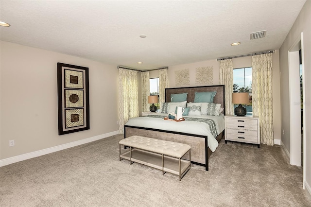 carpeted bedroom featuring a textured ceiling