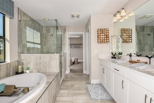 bathroom featuring vanity and plus walk in shower