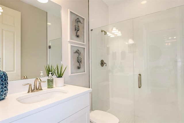 bathroom featuring vanity, toilet, and walk in shower