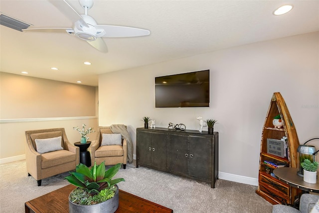 sitting room featuring carpet and ceiling fan