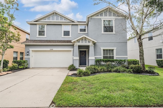 view of front of property featuring a front yard and a garage