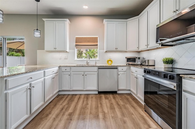 kitchen with sink, decorative light fixtures, white cabinetry, light hardwood / wood-style floors, and appliances with stainless steel finishes