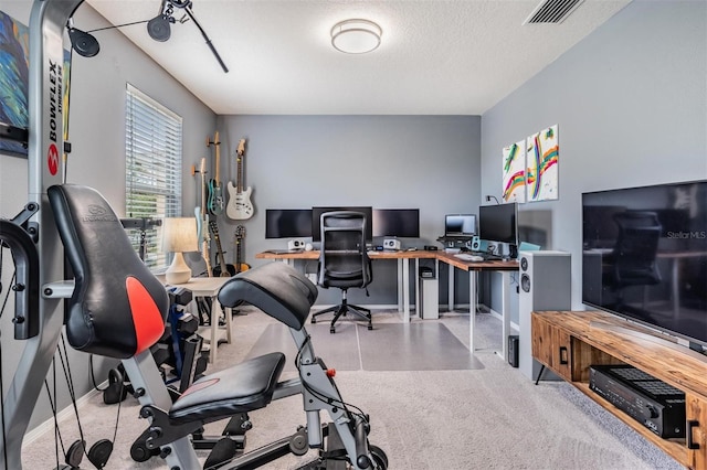 carpeted office space featuring a textured ceiling