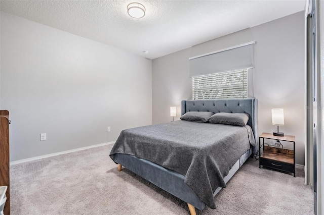 bedroom with a textured ceiling and carpet