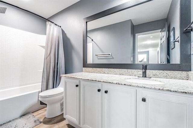 full bathroom featuring toilet, vanity, hardwood / wood-style floors, and shower / bathtub combination with curtain