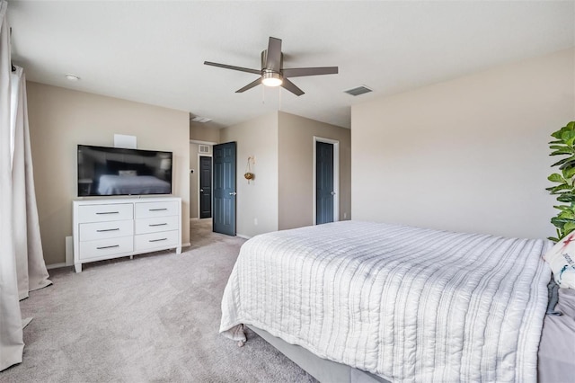 bedroom with ceiling fan and light colored carpet