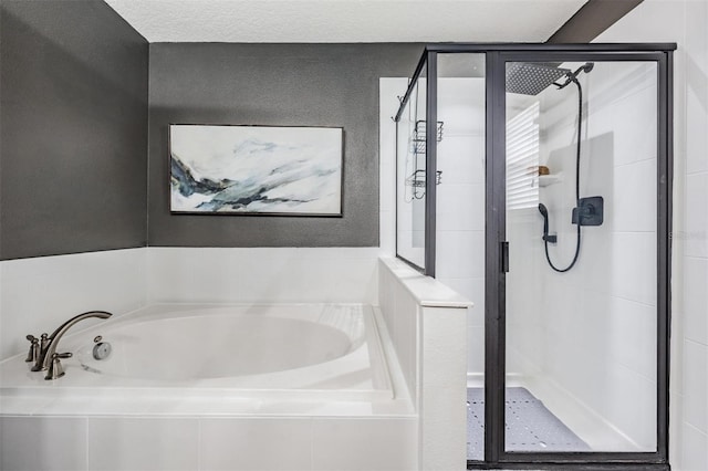 bathroom featuring a textured ceiling and plus walk in shower