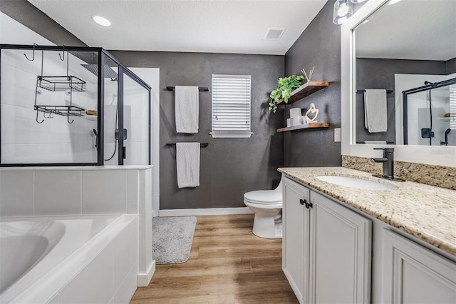 full bathroom featuring shower with separate bathtub, toilet, vanity, and wood-type flooring