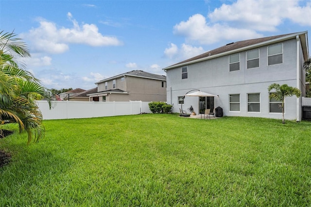 back of property with a patio and a yard