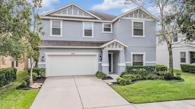 view of front of home with a front yard and a garage