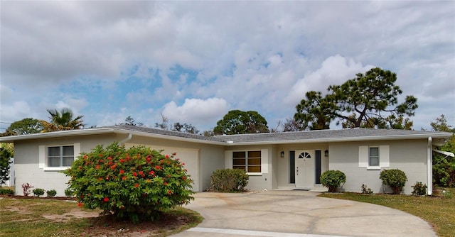 ranch-style home featuring a garage