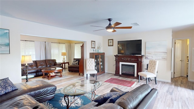 living room with ceiling fan and light hardwood / wood-style floors