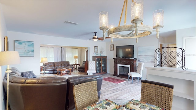 living room featuring ceiling fan and light wood-type flooring