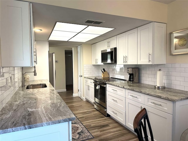 kitchen featuring white cabinetry, sink, and appliances with stainless steel finishes