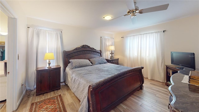 bedroom with ceiling fan and light hardwood / wood-style flooring