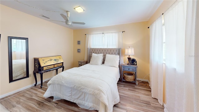 bedroom with light hardwood / wood-style floors and ceiling fan