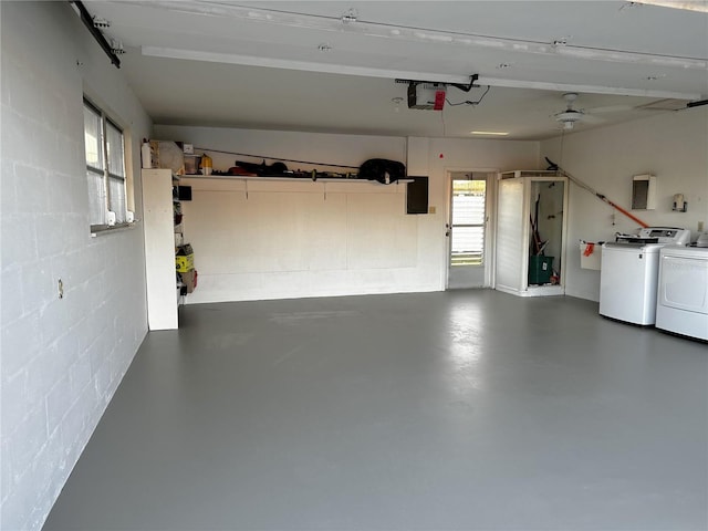 garage with washer and dryer and a garage door opener