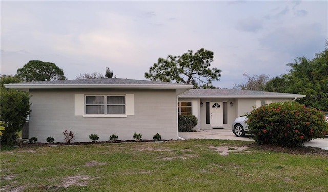 ranch-style home with a front lawn