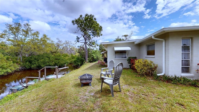 view of yard with an outdoor fire pit