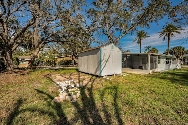 view of yard featuring a storage unit and a sunroom