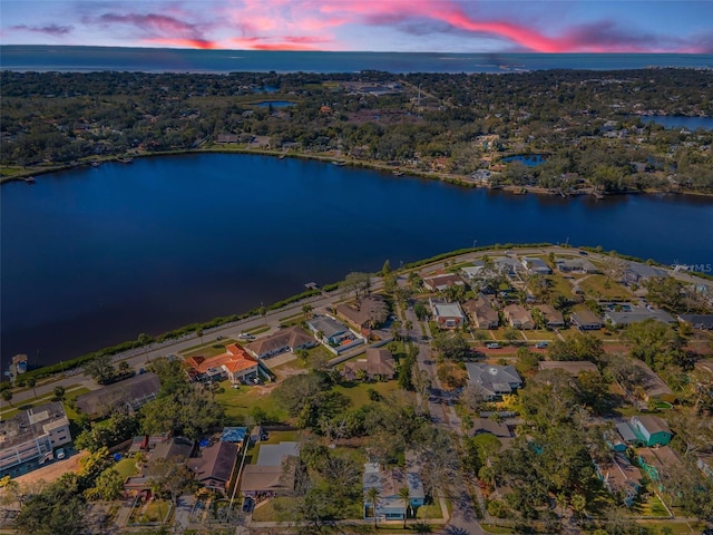 aerial view at dusk with a water view